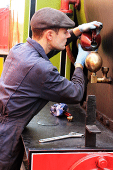 a driver preparing a steam locomotive for operation